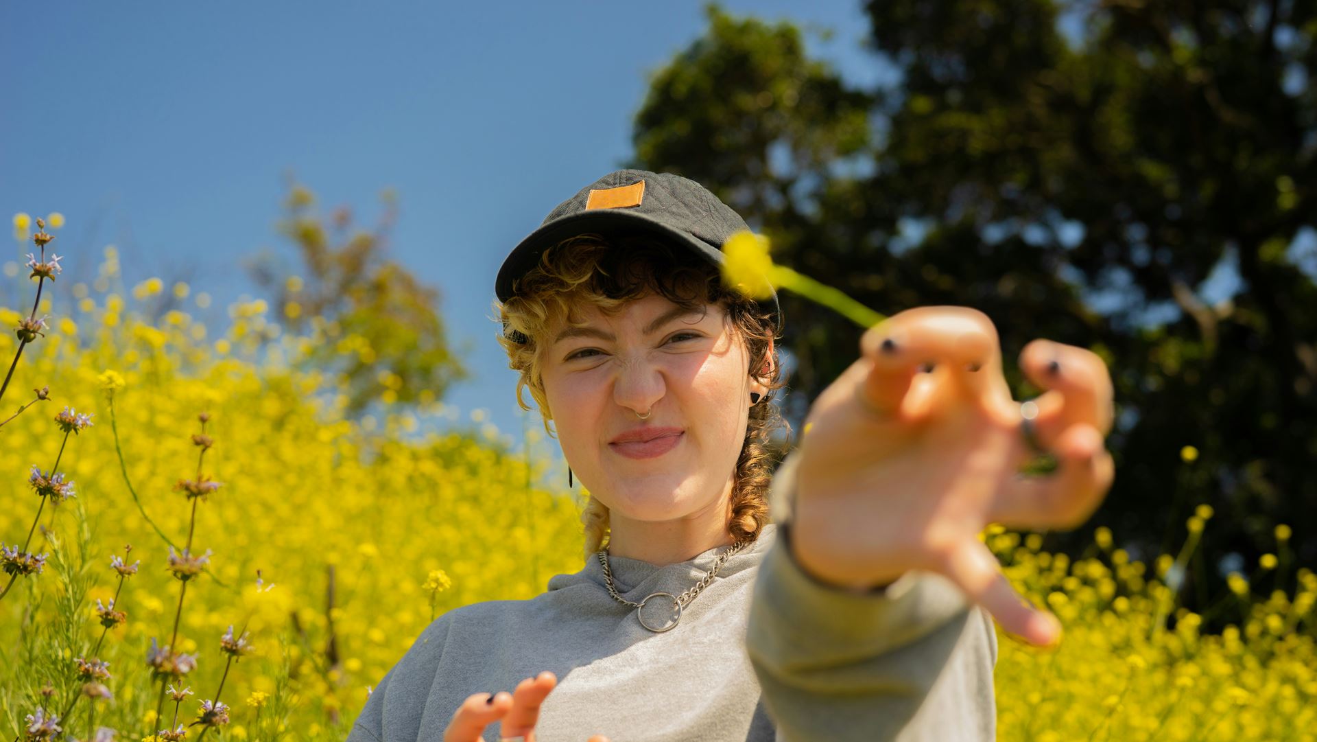 a young girl holding a yellow flower